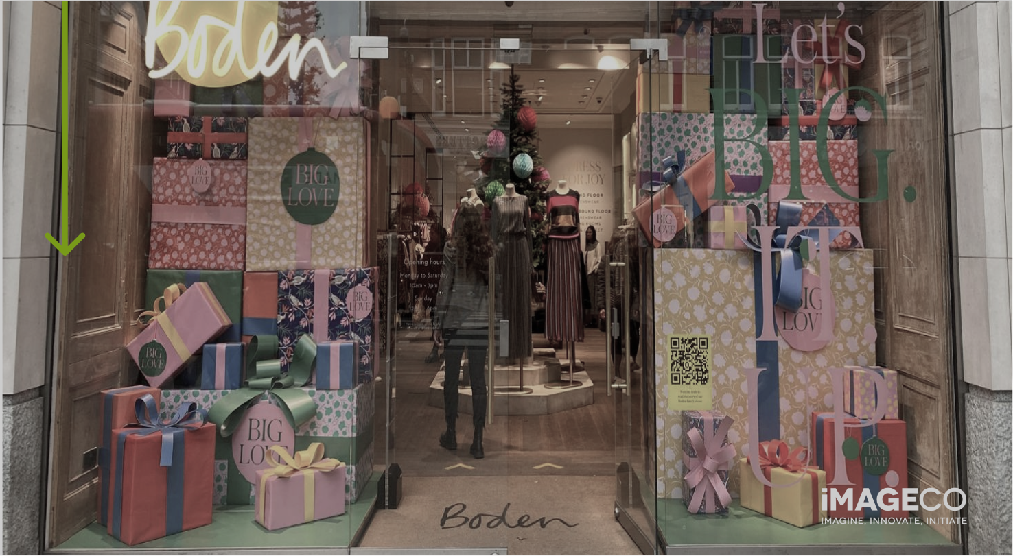 Picture of a Christmas window display with colourful presents created from cardboard for Boden