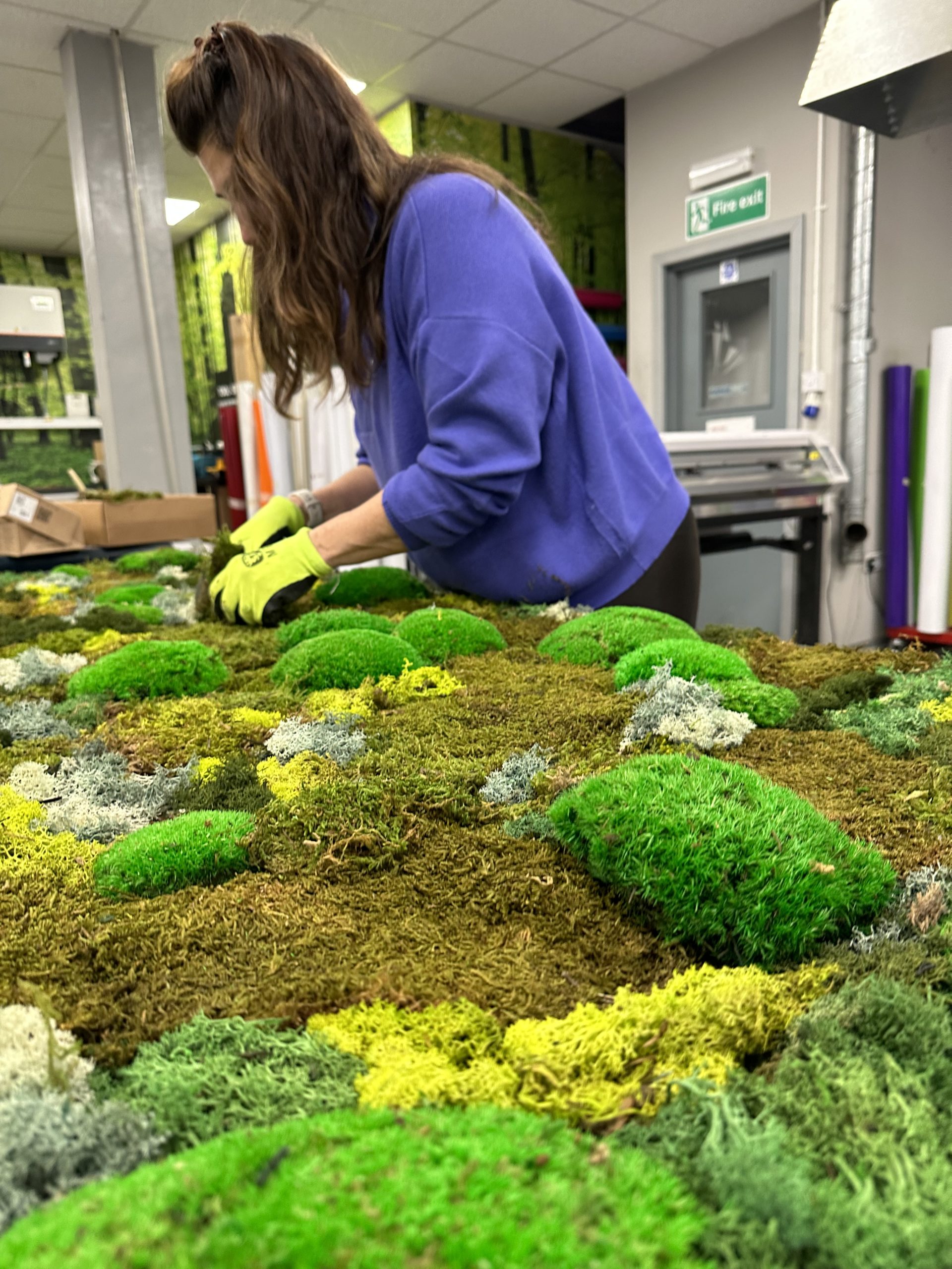 Our floral specialist working on a moss wall