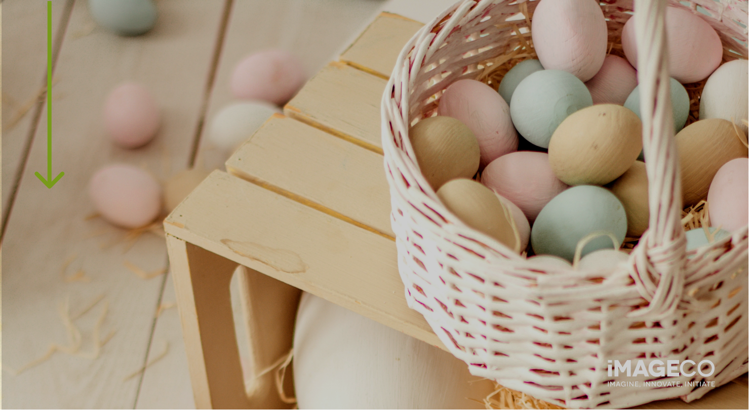 An Easter Basket filled with colourful eggs on a table.